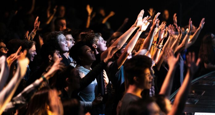 Crowded Ukrainian church service in Portland with worshippers praying together during Sunday service