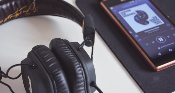 Portland singer writing sad music while rain hits café window